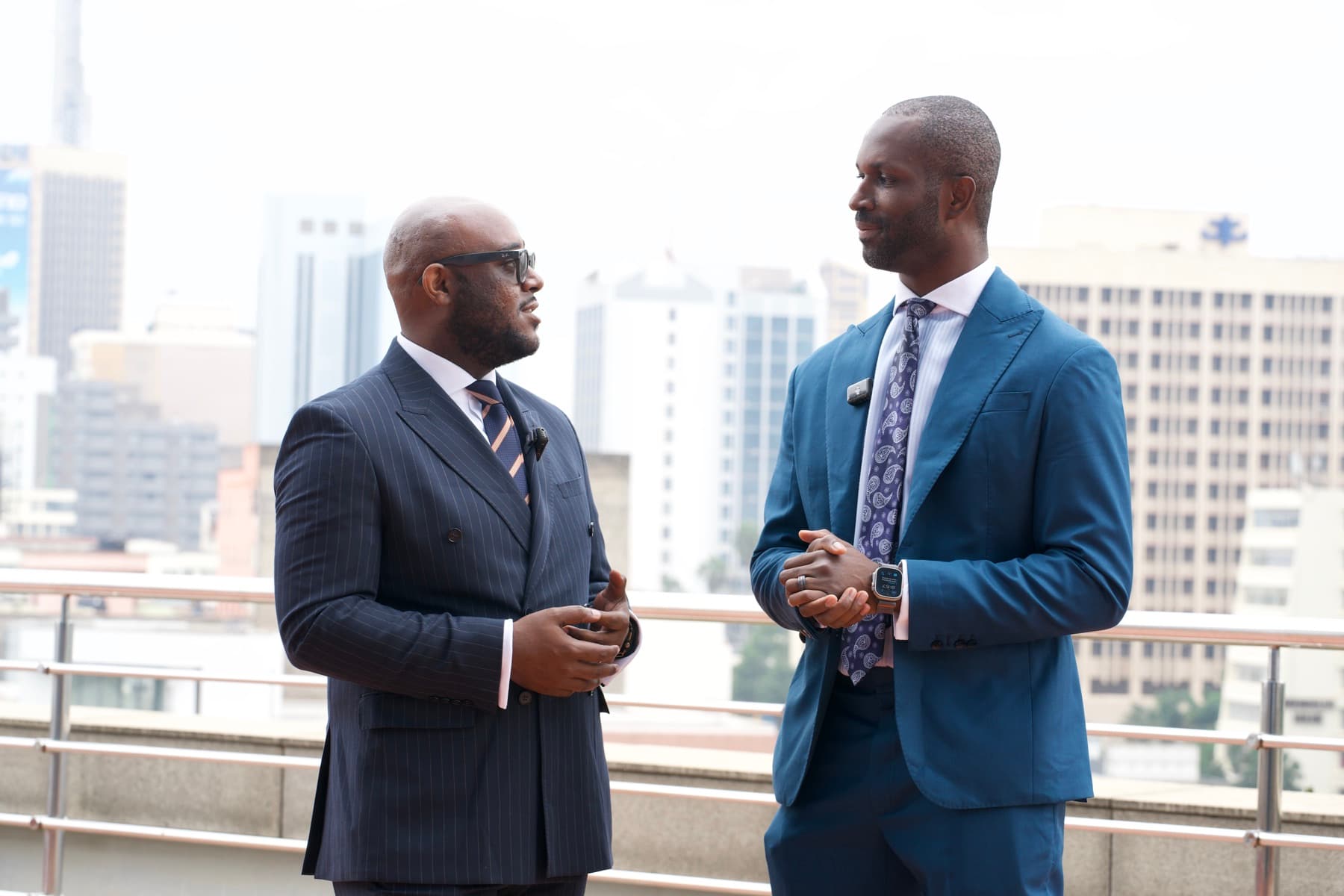 Lorenzo in conversation with a fellow leader against the Nairobi skyline
