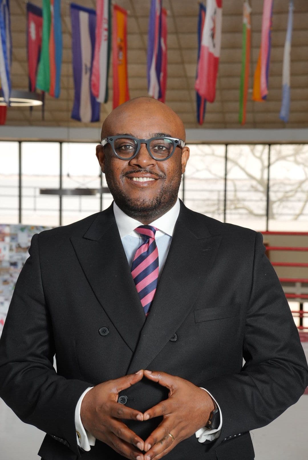 Lorenzo Daughtry-Chambers smiling beneath international flags